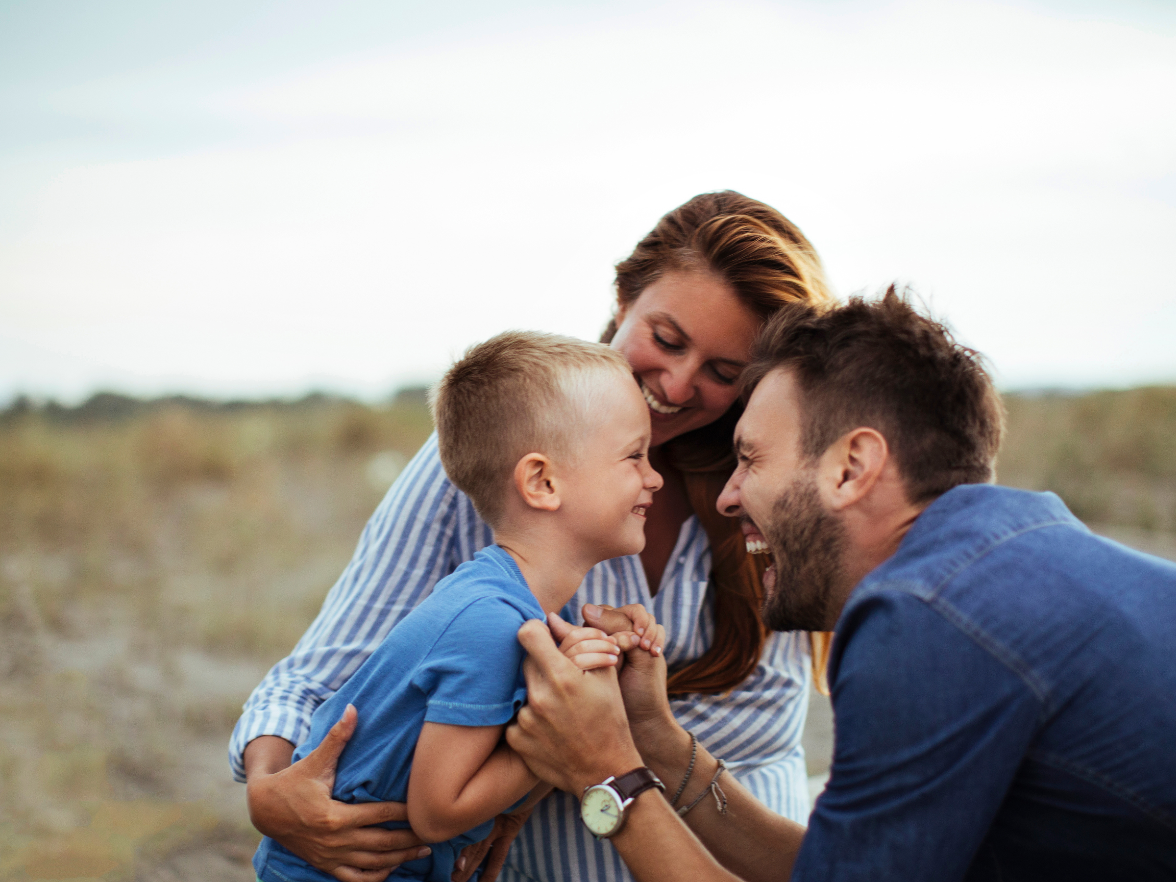 Boy and his parents in field